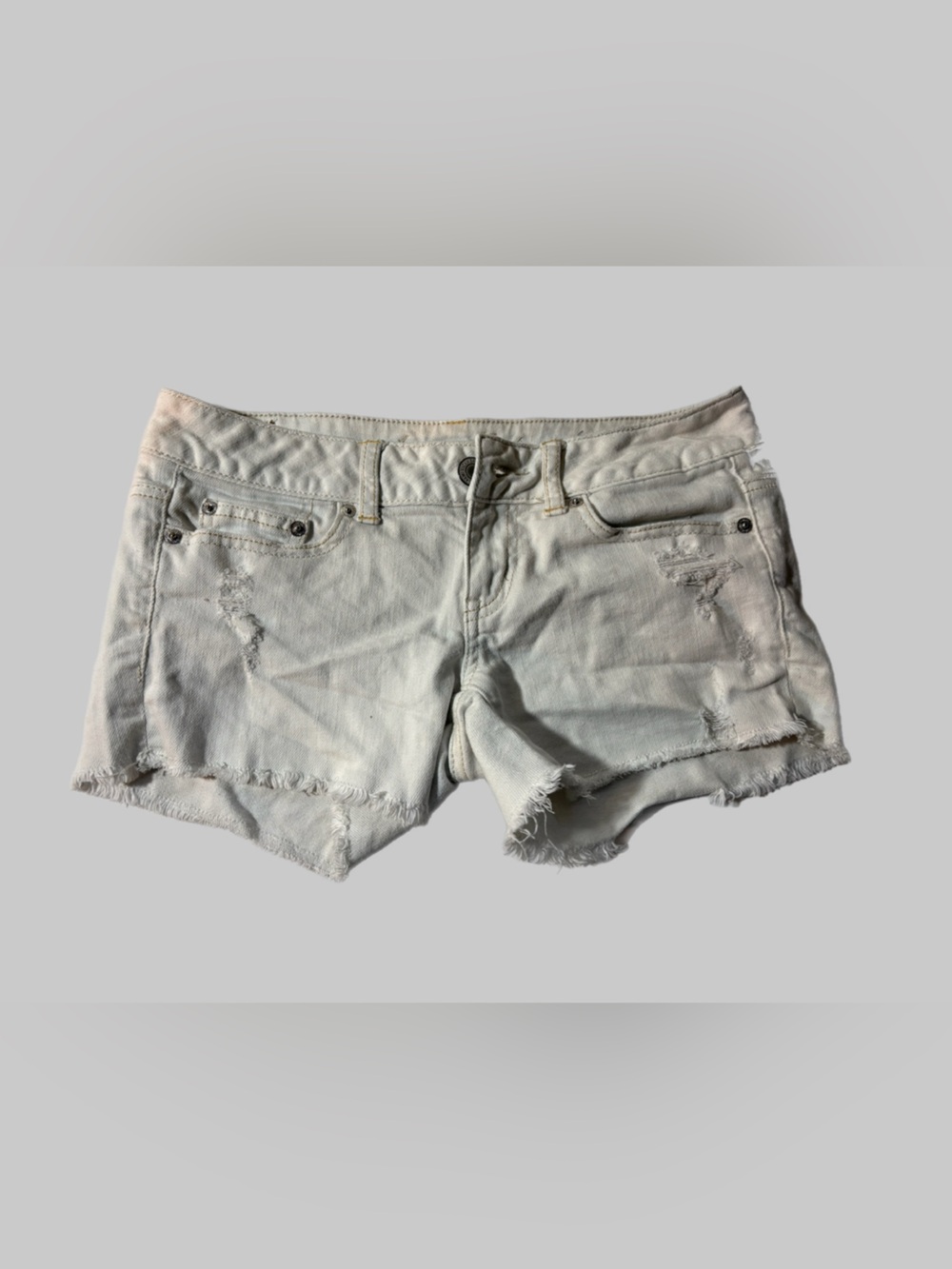 American Eagle Outfitters Low Rise Off-White Distressed Denim Cutoff Shorts